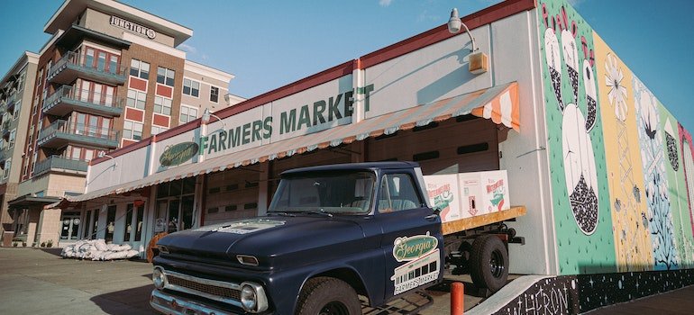 Blue pickup truck parked in front of Farmers Market