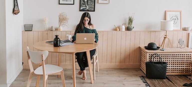 a wioman reading on the laptop storage tips for staging Manhattan apartment