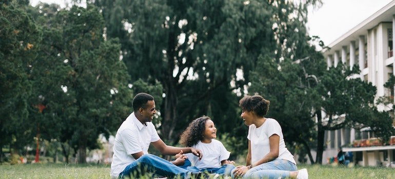 Family sitting on a grass in the park