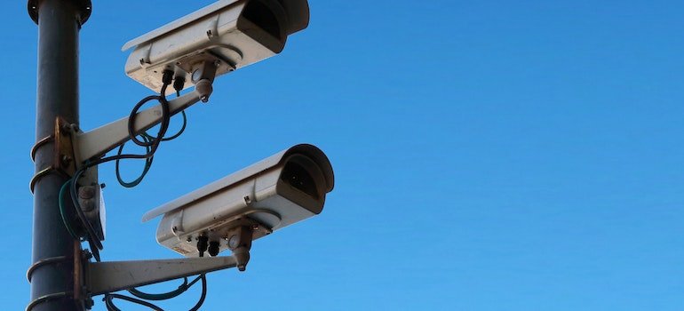 Surveillance cameras against blue sky