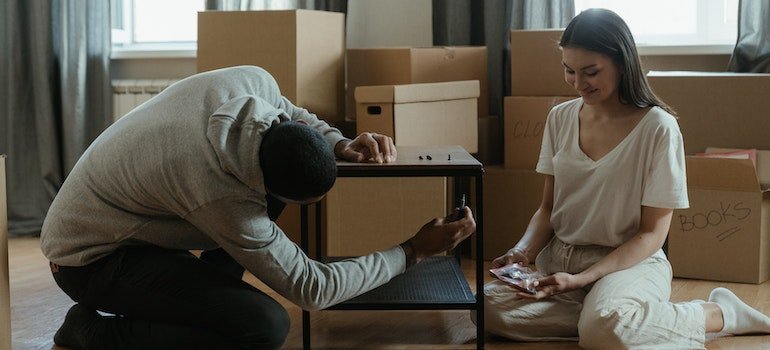 A couple disassembling a coffee table
