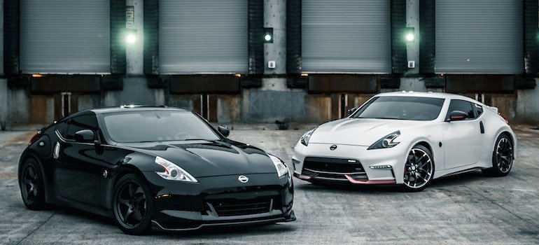 Shiny new coupe cars parked near warehouse - move in with your partner in NYC.