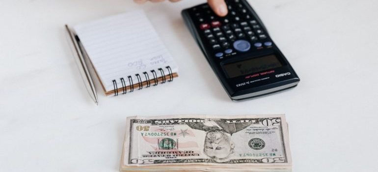 Notepad, calculator and tax money are on the budget friendly moving tips list