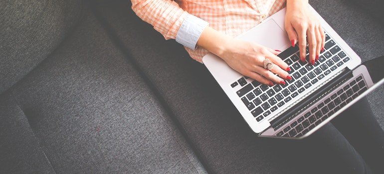 a woman reading on a laptop about things that should never be stored in a storage unit