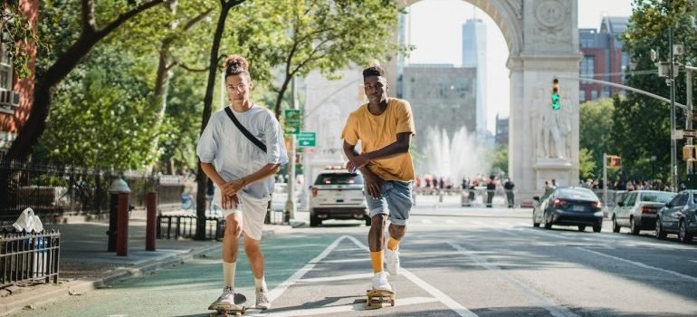 Two boys skating through one of best neighborhood to rent in Manhattan