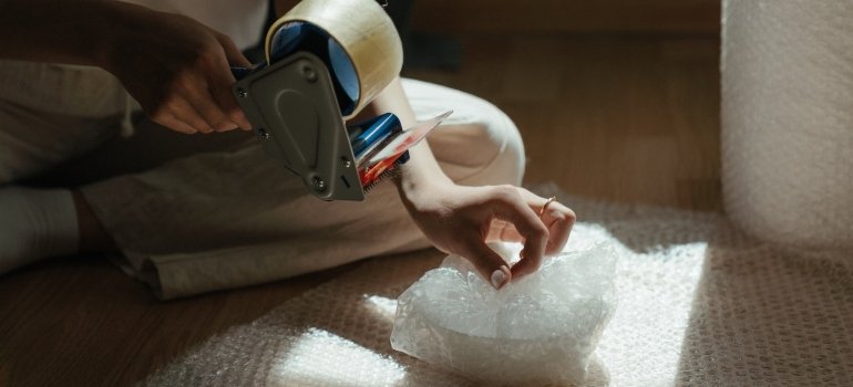 Picture of a person wrapping an item in bubble wrap