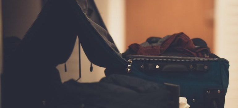 Suitcase with stuff on the table