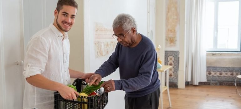 Young man helping senior man