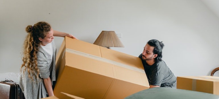 Man and women carrying boxes
