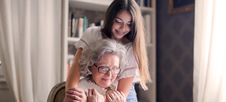 Granddaughter and grandma hugging and smiling