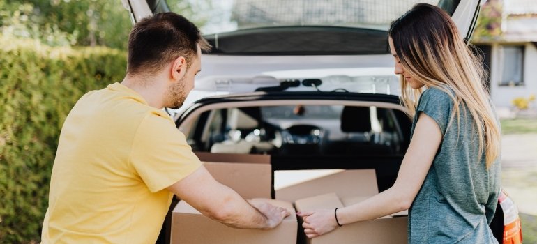 Picture of two people packing a car