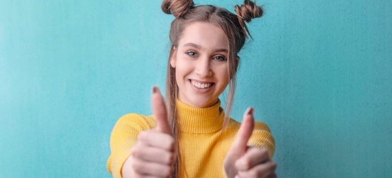 A young girl showing thumbs up for choosing one of the most expensive neighborhoods to live in the Bronx.