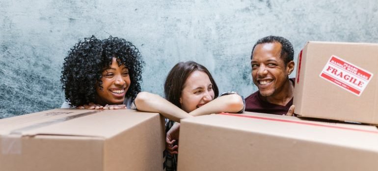 People behind boxes smiling at each other