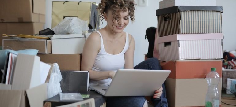 A girl browsing on her laptop on Finding the Right Home Organization Solutions in NYC
