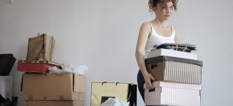 A girl carrying boxes