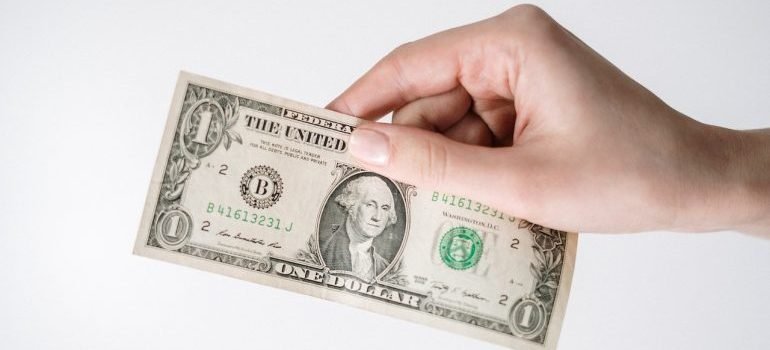 Dollar bill in person's hand