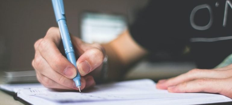 A person writing in their notebook