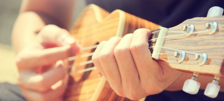 A person playing a small guitar