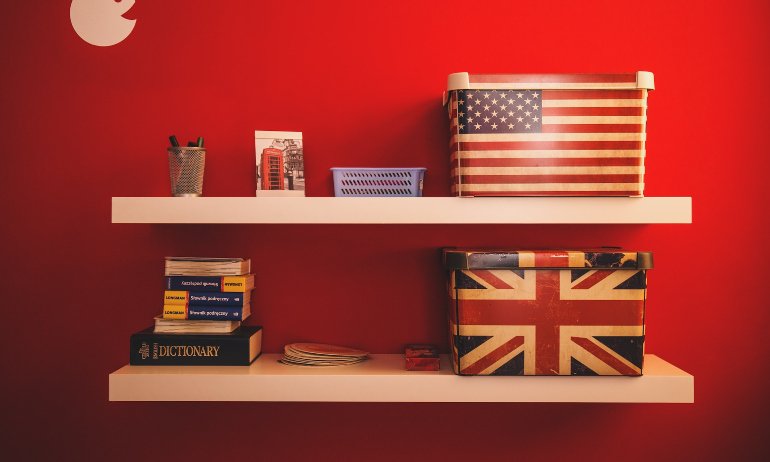 Two floating shelves on a red wall.