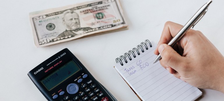 A person creating a realistic budget when moving to Long Island City