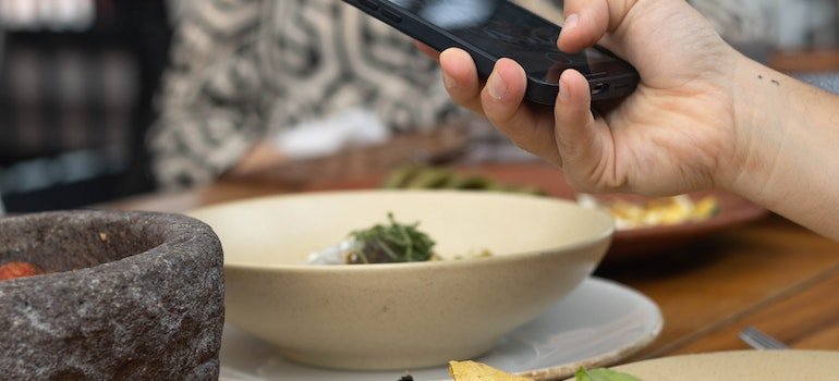 a person taking picture of a plate