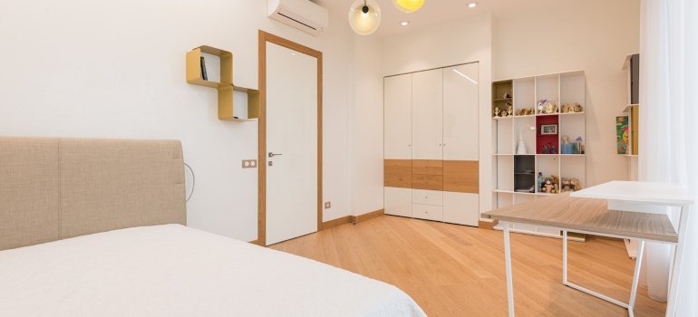 A bedroom with built-in wardrobe and selves.