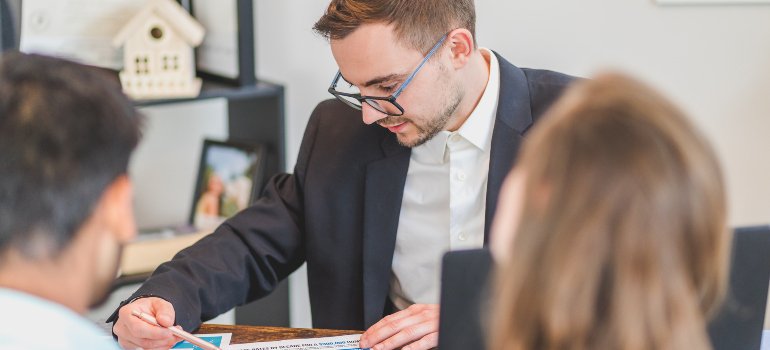 A real estate agent discussing something with his clients.