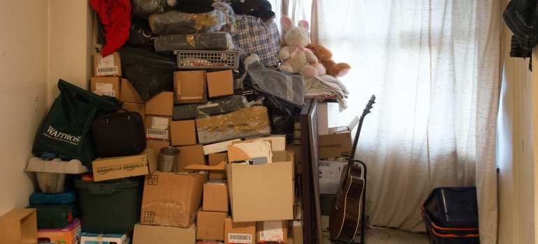 a large pile of various boxes and items in a corner of a room