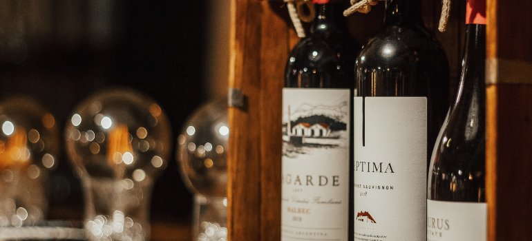 three wine bottles in a wooden box