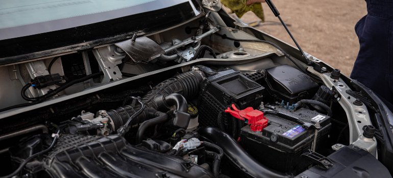 an open hood of a car with all the parts located there exposed
