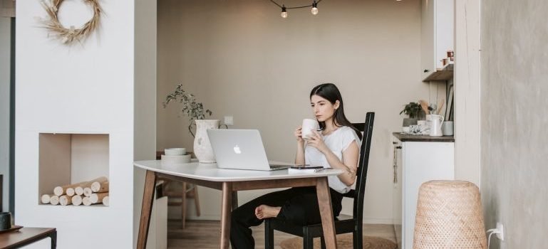 A person on a laptop thinking about renting storage units Morrisania locals recommend