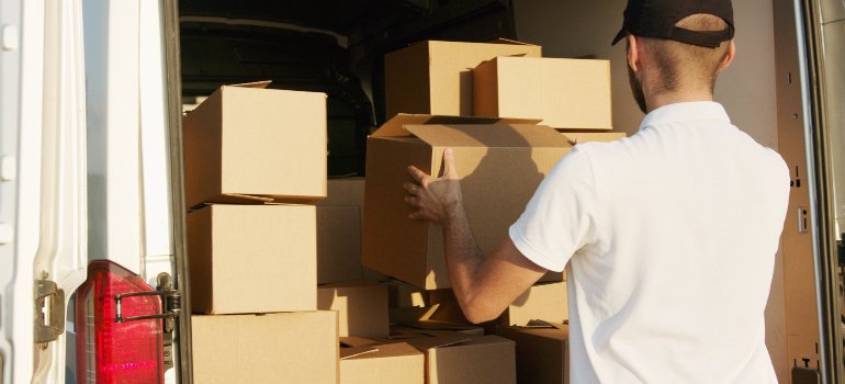 a professional mover placing boxes into a van