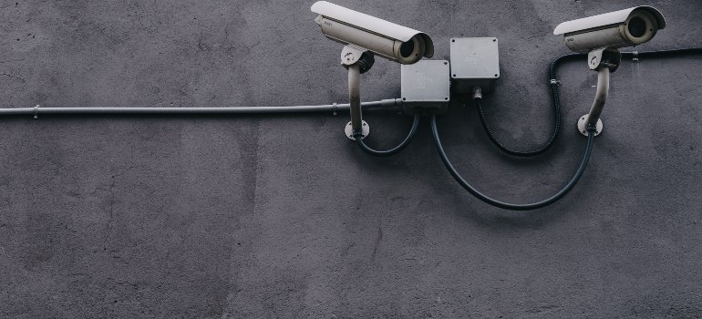 surveillance cameras on a wall, which you should ask for when you want to rent a storage unit for personal and commercial needs