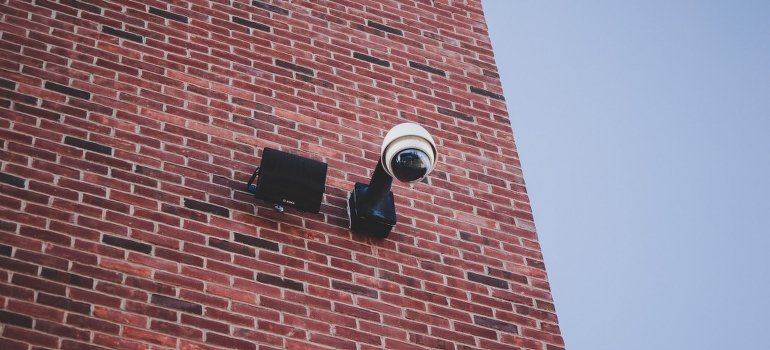 Surveillance camera on the brown brick wall of the best storage Riverdale NY has to offer.