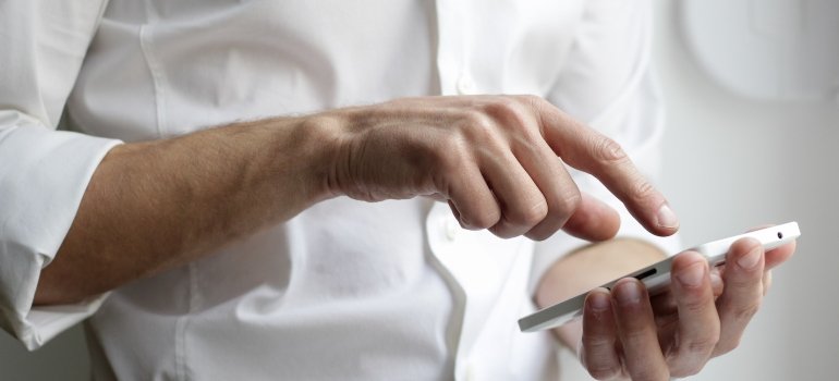 A person using a smartphone to search for the storage Bronx NY locals recommend