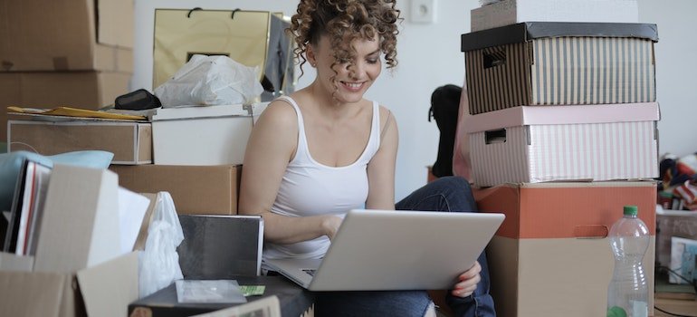 A person using a laptop to look up storage units Harlem has to offer.