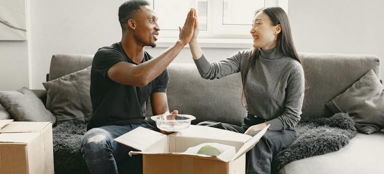 A happy couple unpacking after moving to East Harlem