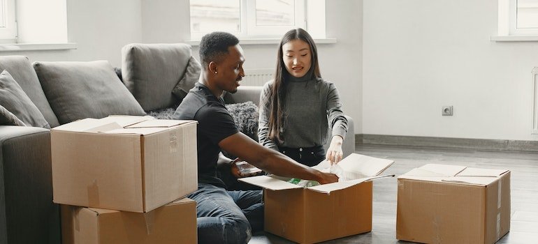 A couple packing their items they want to take to storage Soho residents use when they want to declutter their homes