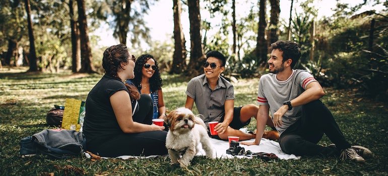Group of friends sitting in a park after moving to the Upper West Side