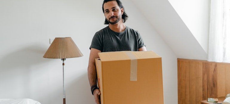 A person holding a box after decluttering their home