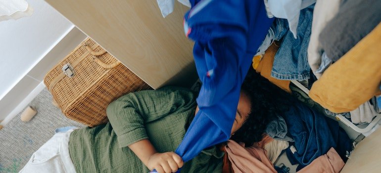 A child playing with clothes