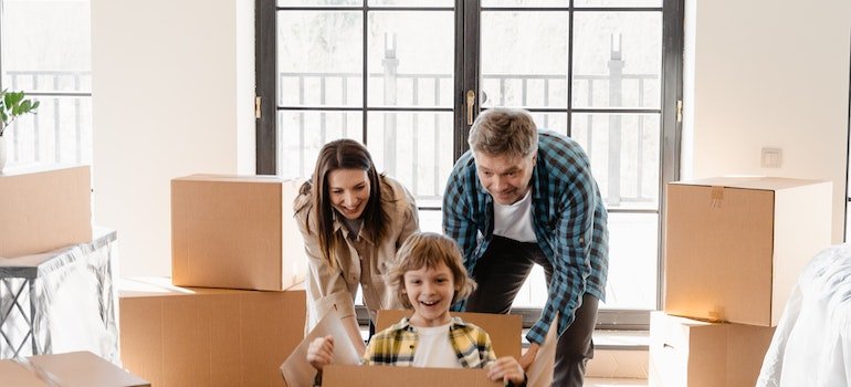 A happy family packing their items that will be kept in storage Chelsea locals always choose