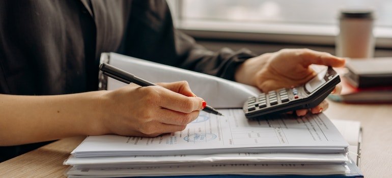 A person organizing documents, which is one of the efficient storage tips for a seamless transition into fall