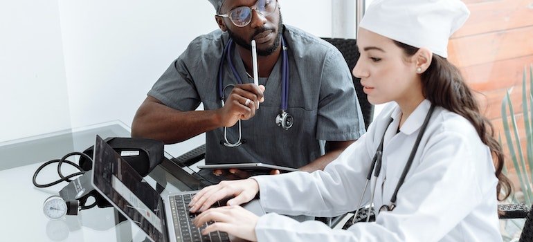 Medical professionals using a laptop