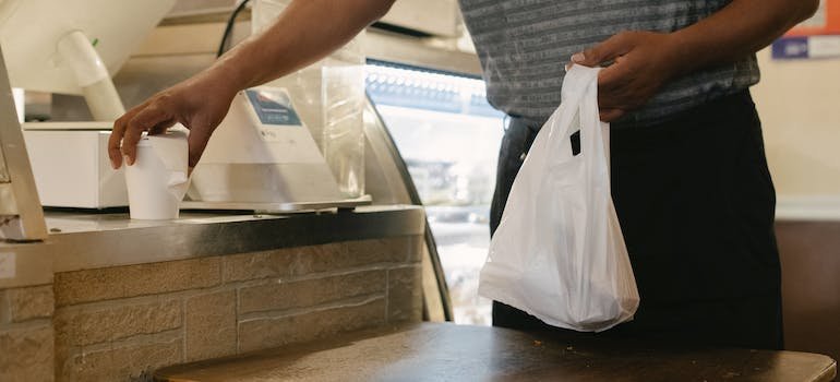 A person picking up their coffee