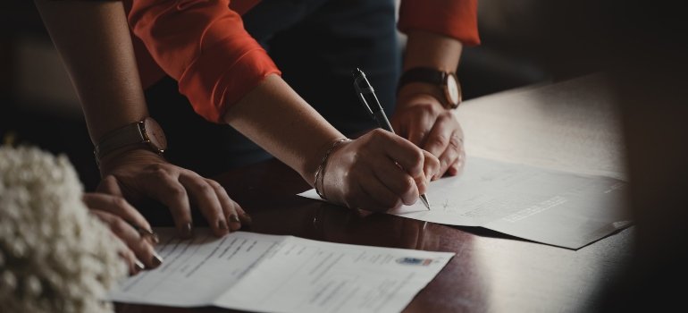 A person signing a contract to rent storage Bronx NY locals rely on