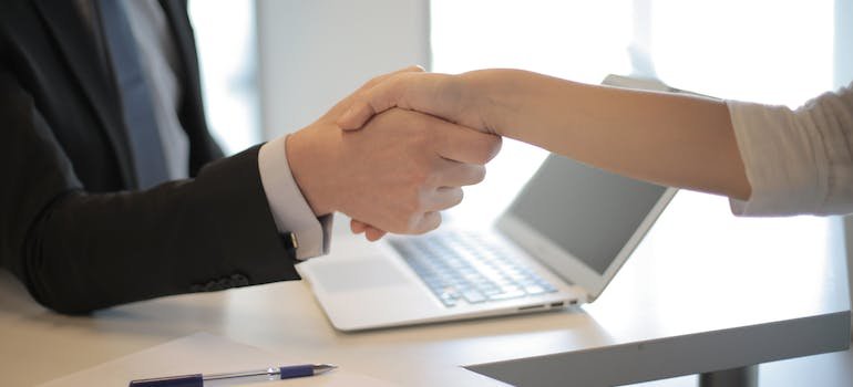 Two people shaking hands, agreeing on terms about renting storage Hell's Kitchen locals always use
