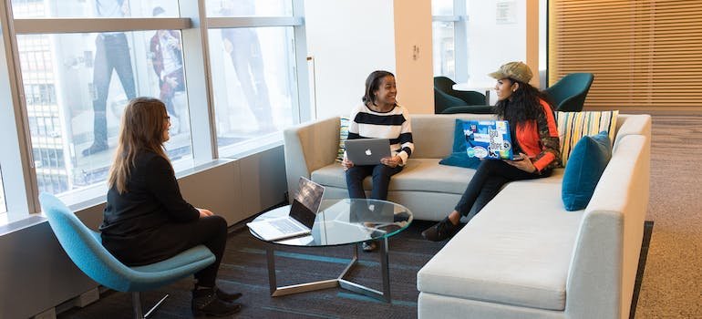 three people in an office talking about moving to Kingsbridge
