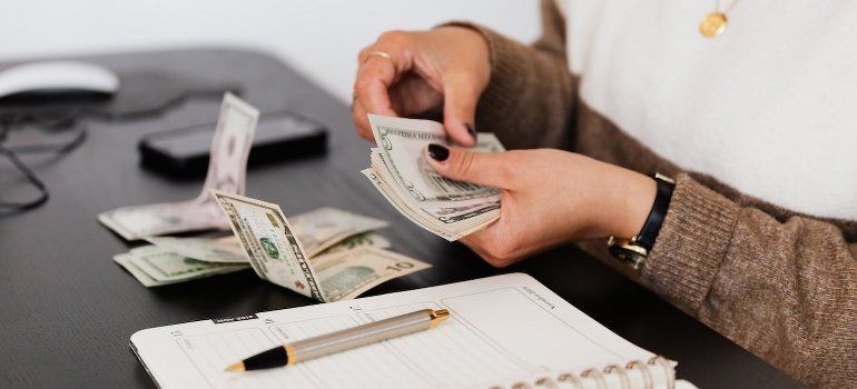 A person counting dollar bills.