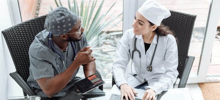 Two doctors talking about moving to Kingsbridge